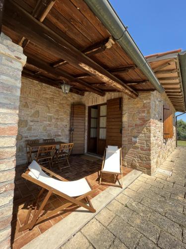 a patio with two lounge chairs and a table at Agriturismo Il Gonzeto, Montepulciano in Montepulciano
