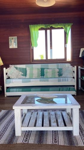 a living room with a coffee table and a couch at La Tatuira, Cabana Amarela in Pinheira