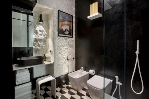 a bathroom with a toilet and a sink at CocoMorghen Apartment in Naples