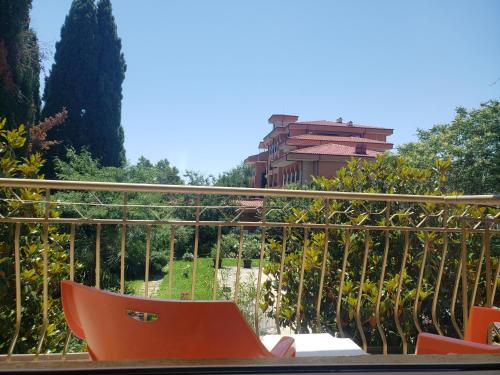 an orange skateboard sitting on a rail next to a fence at Family Hotel Magnolia, Sunny Beach in Sunny Beach