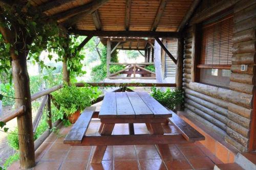 a wooden picnic table sitting on a patio at El Mirador de la Mancha in Villarrubia de los Ojos