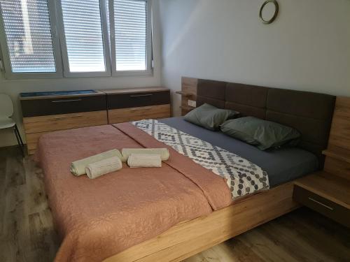 a bedroom with a bed with two towels on it at Apartment Mini in Kumanovo