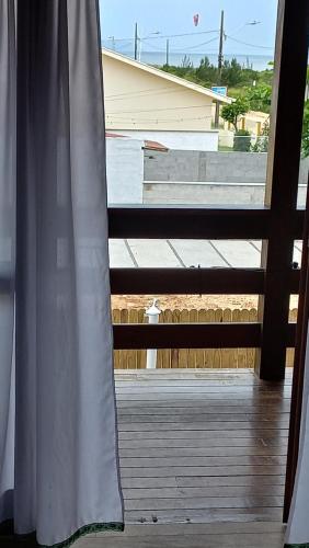 a window with a view of a building at La Tatuira, Cabana Amarela in Pinheira