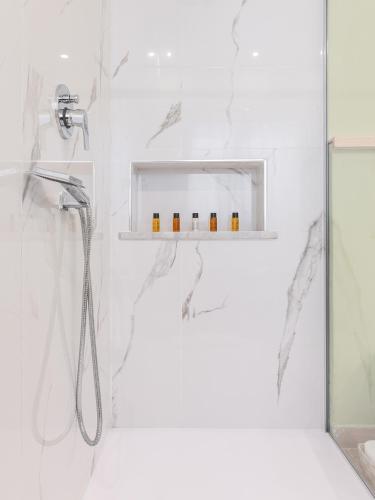 a bathroom with a shower with a shower head at Villa Iole Apartment in Carloforte