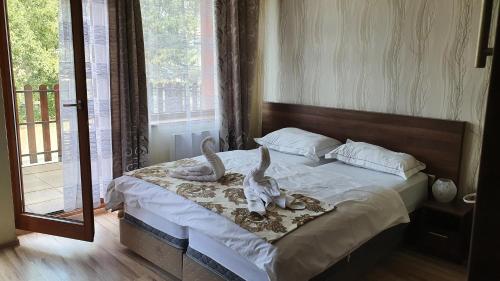 a bedroom with a bed with stuffed animals on it at Apartmánový Wellness Garni Hotel Relax in Senec