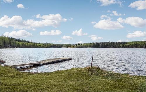 a dock in the middle of a large lake at Cozy Apartment In Torsåker With Wifi in Stjärnsund