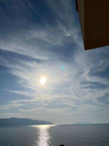 a view of the ocean with the sun in the sky at Lotus Apartments in Vlorë