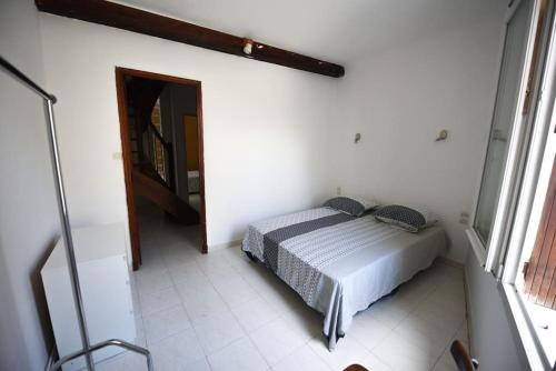 a bedroom with a bed in a white room at Sète - LOFT 6 personnes. CENTRE VILLE / PORT in Sète