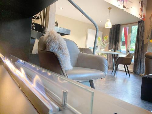 a living room with a chair and a fire place at Bel Air - Propriétés Mont Amour in Montriond