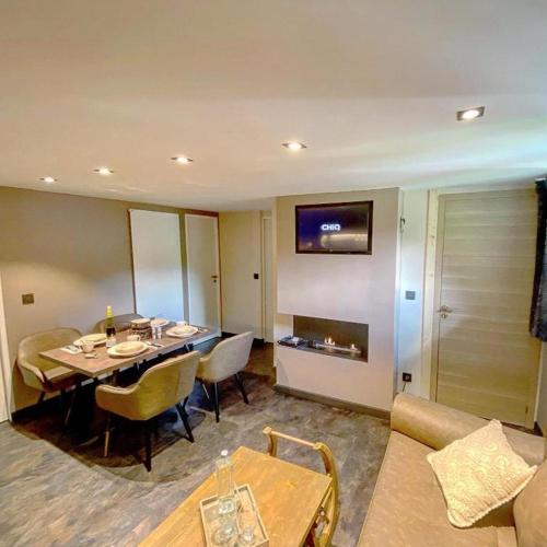 a living room with a table and a couch at Bel Air - Propriétés Mont Amour in Montriond