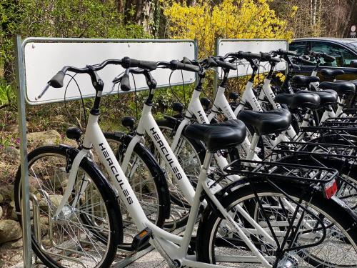 a row of bikes parked next to a sign at Orbisa Pokoje i Apartamenty in Łeba