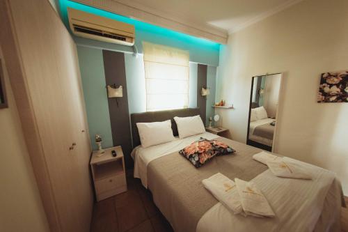 a bedroom with two beds and a mirror at Mario's home in Volos