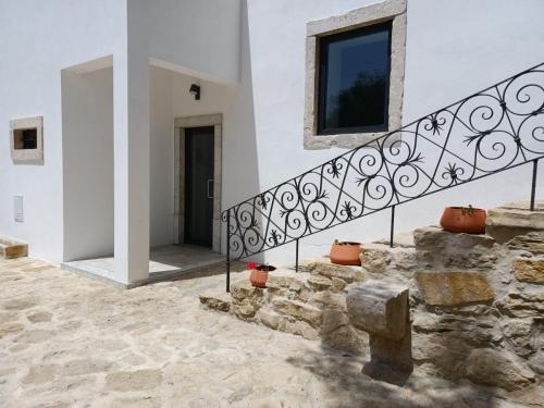 a staircase in a white building with a window at ADEGA Residências Artísticas - Perto de Lisboa in Almargem