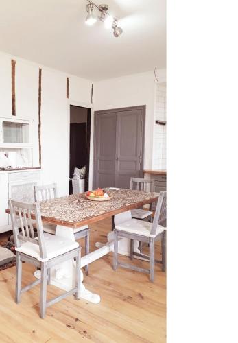 - une table à manger et des chaises dans la cuisine dans l'établissement Manoir Demouret Sarlat, à Sarlat-la-Canéda