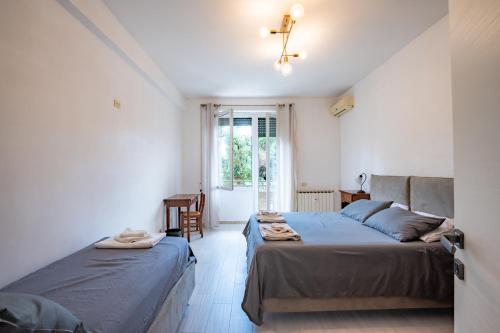 - une chambre avec 2 lits et une fenêtre dans l'établissement La Sapienza APT, à Rome