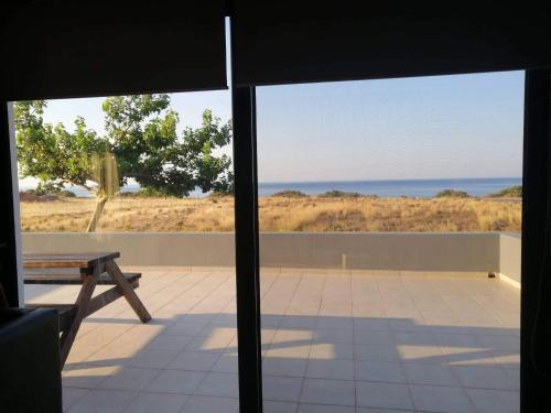 a view of the ocean from the porch of a house at Ledakis House in Frangokastello