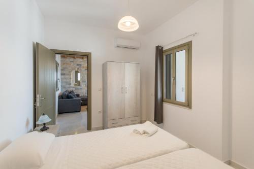 a bedroom with two beds and a mirror at Hercules house pyrgaki paros in Drios