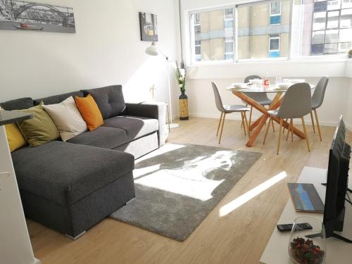 a living room with a couch and a table at OportoView Prestige Apartment in Porto