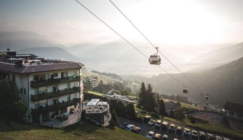 a large mountain range with a ski lift on top of it at Kronplatz-Resort Hotel Kristall in Valdaora