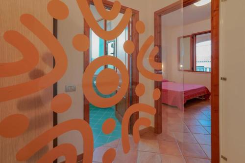 a room with a sign that says stop racism at Capofrascaresort in Sant' Antonio di Santadi