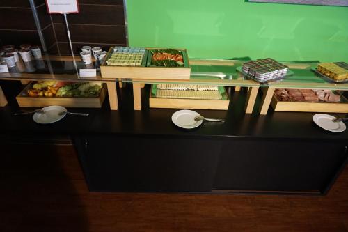 a table with some food on top of it at Hotel am Bahnhof in Waren