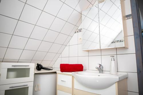 a small white kitchen with a sink and a window at Orgonavirág Apartman in Hajdúszoboszló