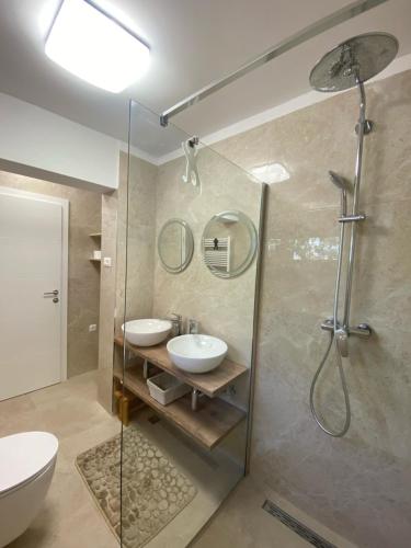 a bathroom with a shower and a toilet and a sink at Sugar house in Pag
