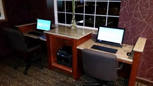 two computers on a desk in a room at Wingate by Wyndham Elkins in Elkins