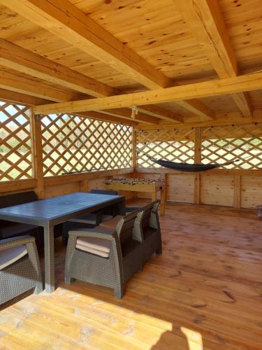 a large room with a table and chairs in a cabin at Oaza spokoju in Ramsówko
