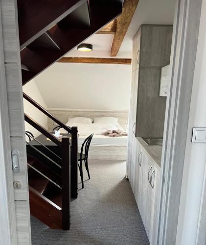 a room with a staircase leading to a bedroom at Resort Mezná in Hřensko