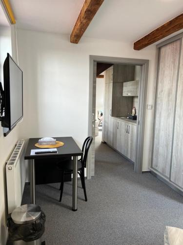 a dining room with a table and a kitchen at Resort Mezná in Hřensko