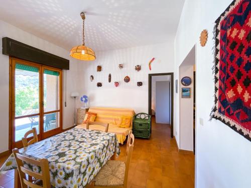 a bedroom with a bed and a table in a room at Appartamento Il Faro 2 in Rio nellʼElba