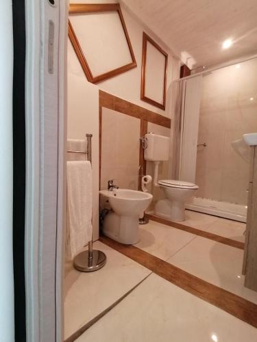 a bathroom with a toilet and a sink at L'Antico Palazzo rooms in Catania