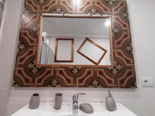 a bathroom with a mirror and a sink at L'Antico Palazzo rooms in Catania