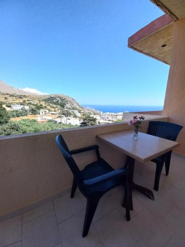 a table and chairs on a balcony with a view at Castro Kerame in Kerames