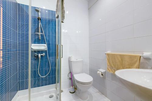 a bathroom with a shower and a toilet and a sink at Modern 1BR Maisonette steps from the Promenade in Sliema