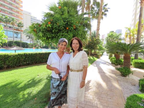 two women standing next to each other in a park at Gemelos 22 - Siroco in Benidorm