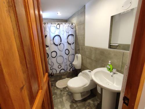 a bathroom with a toilet and a sink at linda house cusco in Cusco