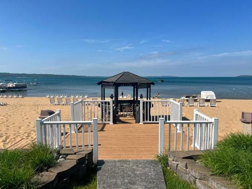 a gazebo on the beach next to the ocean at The Beach Haus - Traverse City in Traverse City