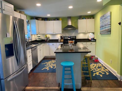 a kitchen with white cabinets and a refrigerator at BEACH HAVEN Dog friendly farmette Great for 2 couples in Berlin