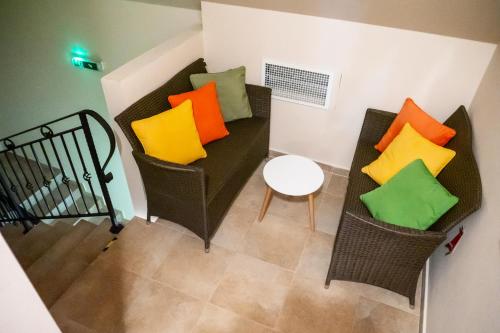 a living room with a couch with colorful pillows at Chata pod Ostrým vrchom in Soblahov