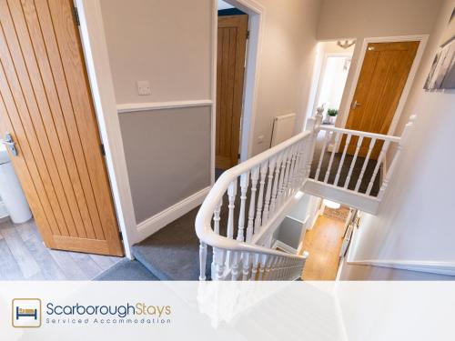 a staircase in a house with a stair case at Scarborough Stays - Ashville Lodge - 5 Bedroomed house - Sleeps 9 in Scarborough