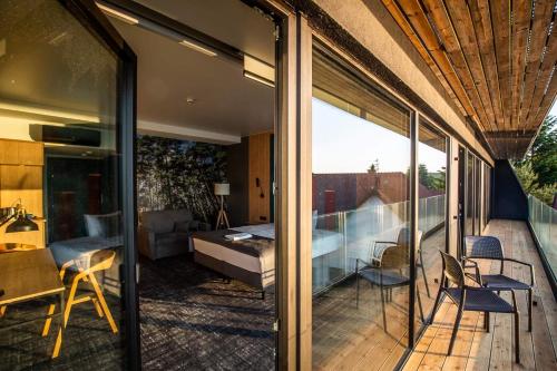 a house with glass doors and a balcony with a bedroom at OTTON-Charzykowy Bed&Restaurant in Chojnice
