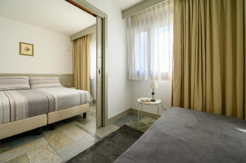 a bedroom with a bed and a large mirror at Alpesmith - Bike & Ski apartments in Bardonecchia