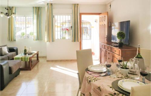 a living room with a table and a couch at Cozy Home In Torrevieja With Wifi in Torrevieja