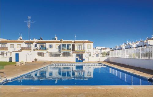 a large swimming pool in front of a building at Cozy Home In Torrevieja With Wifi in Torrevieja