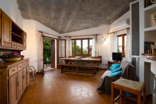 a living room with a couch and a table at Villa Bados 8 - Klodge in Olbia