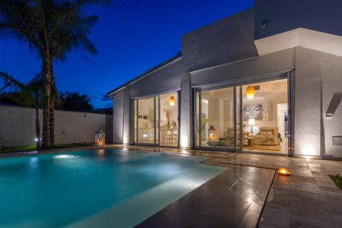 a swimming pool in front of a house at Valentinus in Ugento
