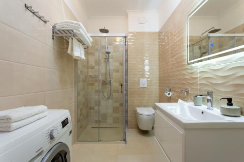 a bathroom with a shower and a toilet and a sink at GAJO DELUXE in Trogir