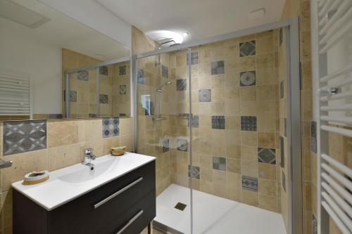 a bathroom with a sink and a shower at Les Jardins de Falguière in Saint-Jean-du-Gard
